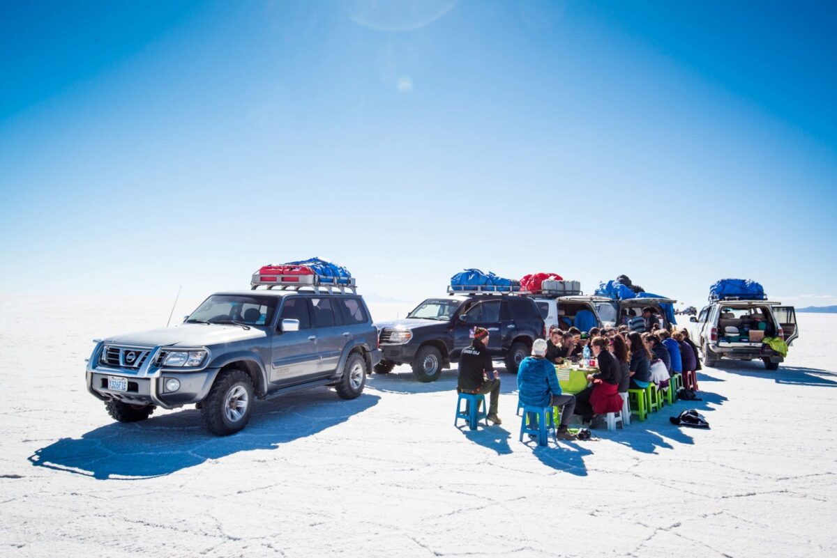 Salar de Uyuni Salt Flats Team having lunch by the Jeeps Hero Alex Frood Bolivia